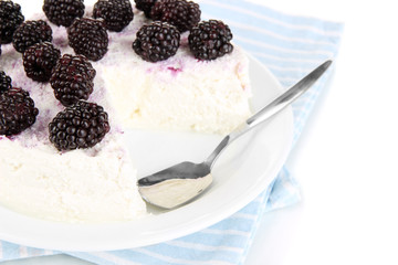 Cheesecake with fresh berries on white plate closeup