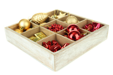 Wooden box filled with christmas decorations, isolated on white