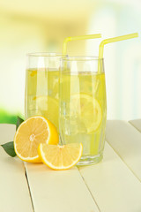 Delicious lemonade on table on light background