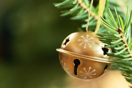 Jingle bell on Christmas tree with copy space.