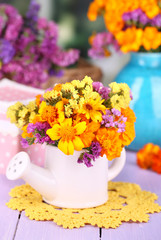 Bouquet of marigold flowers in watering can