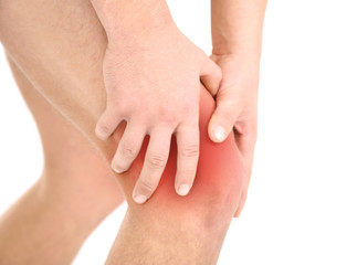 Young man with knee pain, isolated on white