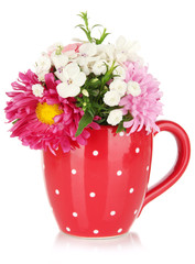 Beautiful bouquet of bright flowers in color mug, isolated