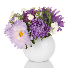 Obraz premium Beautiful bouquet of bright flowers in glass vase, isolated