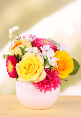Beautiful bouquet of bright flowers in color vase,