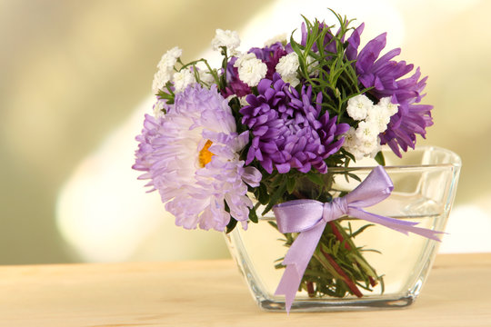 Beautiful bouquet of bright flowers in glass vase,