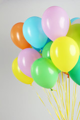 Colorful balloons on grey background