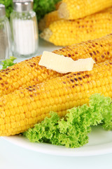 Delicious golden grilled corn with butter close-up