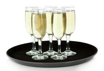 Many glasses of champagne on the tray, isolated on white