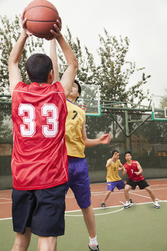 Two teams playing basketball 