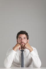 Portrait of a young businessman thinking.