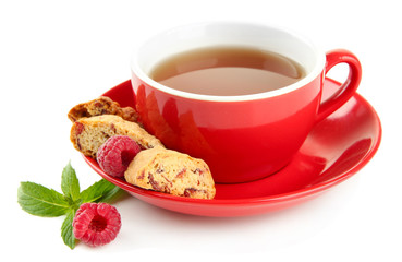 Cup of tea with cookies and raspberries isolated on white