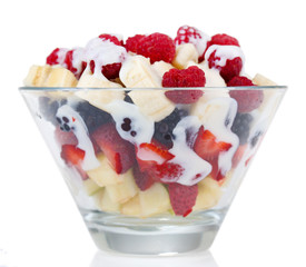 Fruit salad in glass bowl, isolated on white