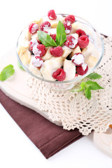 Fruit salad in glass bowl, isolated on white