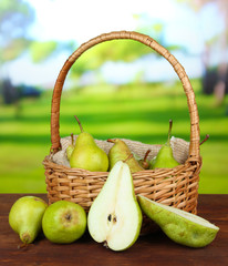 Pears in  wicker basket, on bright background