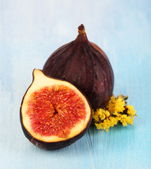 Ripe figs on blue wooden table close-up
