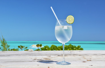 Glass of water on the tropical beach