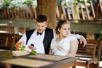Bride and groom having fun at cafe