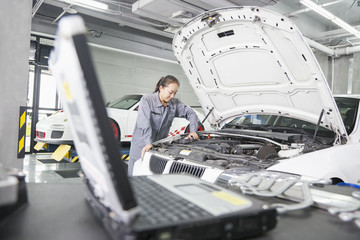 Female Mechanic working in Auto Repair Shop