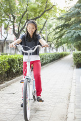 Young Girl Riding Her Bicycle