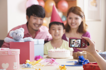 Obraz na płótnie Canvas Family Having Their Picture Taken at Their Son's Birthday