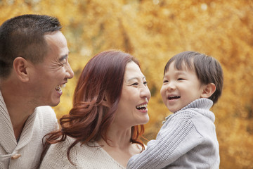 Fototapeta premium Family Enjoying a Park in Autumn