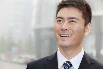 Young Businessman Smiling and Looking Away, Portrait