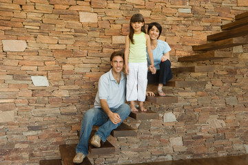 Girl and parents on stairs