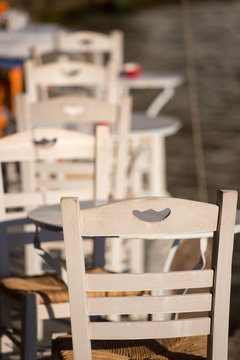 Close-up from a white chair and white table.