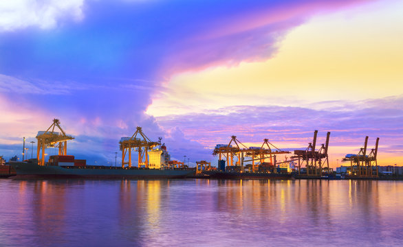 Container Cargo freight ship with working crane bridge in shipya