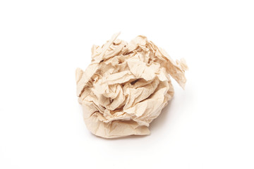 Crumpled brown tissue paper ball on white background