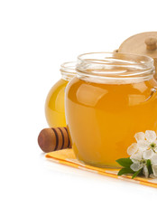 glass jar full of honey and stick