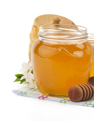 glass jar full of honey and stick