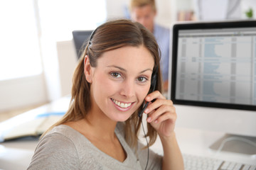 Beautiful smiling teleoperator with headset on