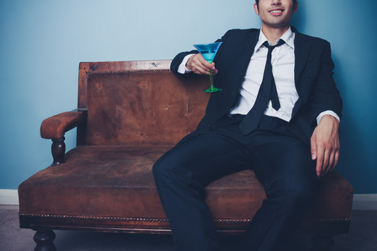 Businessman relaxing with a cocktail after work