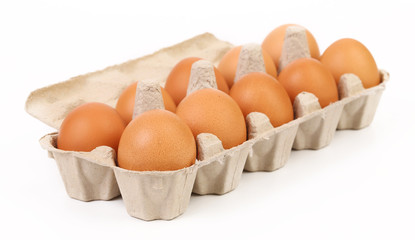 Ten brown eggs in egg box