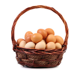 Eggs in basket on white background