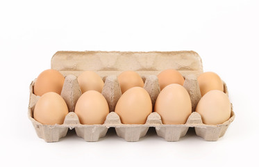 Ten brown eggs in egg box