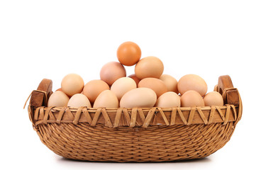 Brown eggs in the basket on white