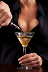 Barmaid mixing drink