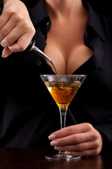 Barmaid mixing drink