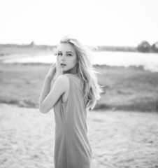 Beautiful blonde in a dress outdoors
