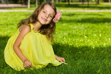 Fototapeta premium Smiling young girl on the grass