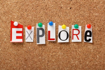 The word Explore on a cork notice board