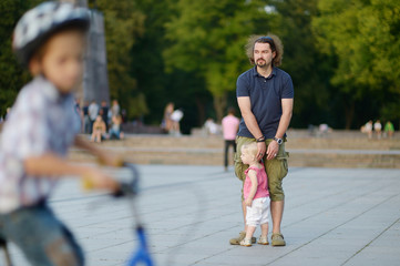 Young father and his toddler girl outdoors