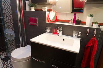 Modern bathroom interior with red accents