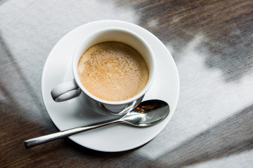 Cup of coffee on a wooden table