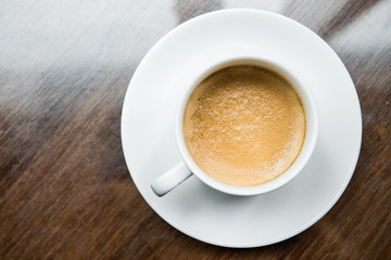 Cup of coffee on a wooden table
