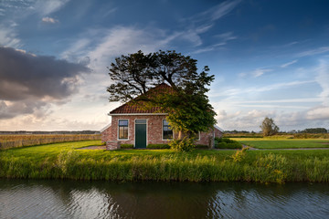 Obraz premium charming farmhouse by river