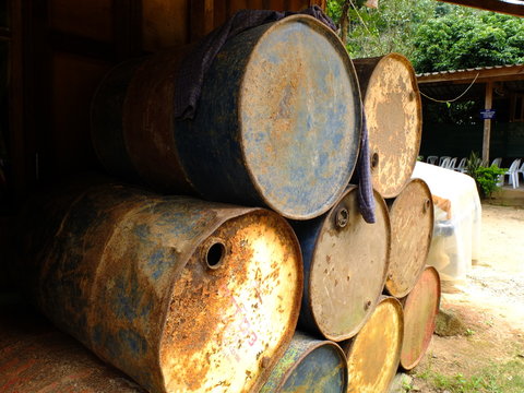 pile of rusty old empty oil barrel